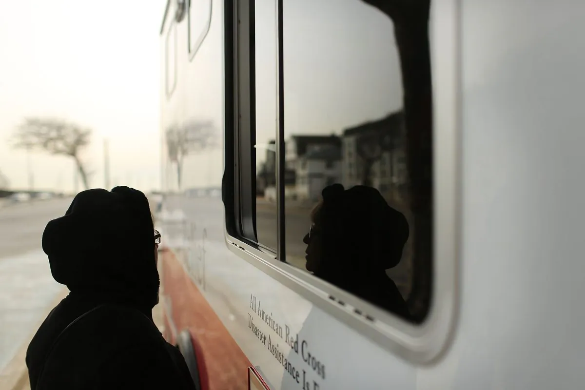 A woman waits for food at the window of Red Cross Disaster Relief truck in the Rockaways following Hurricane Sandy in the Queens borough of New York City on Jan. 25, 2013. (Spencer Platt/Getty Images)