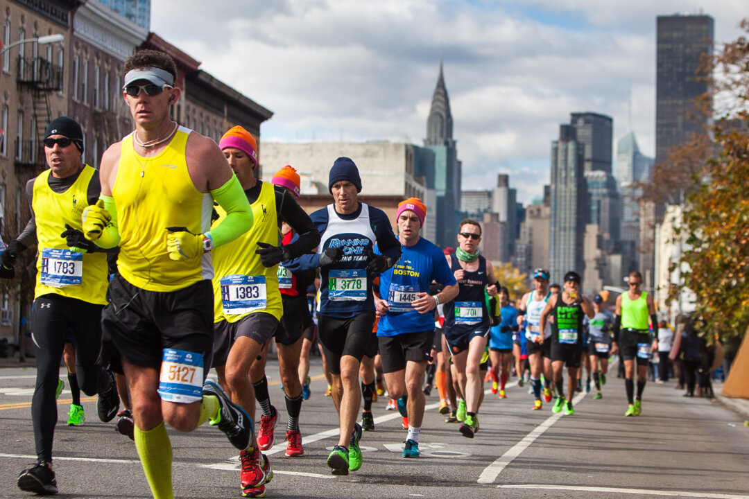 Runners approach the 14.5-mile mark of the New York City Marathon in Queens, New York, Sunday, Nov. 2, 2014. (Petr Svab/Epoch Times)