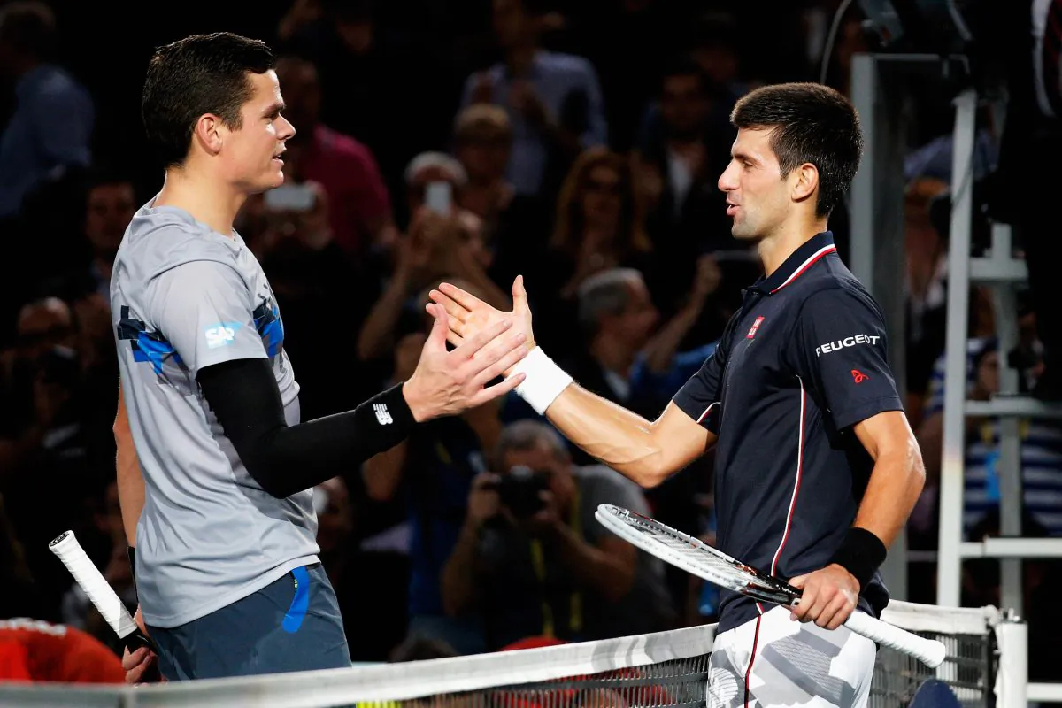 Milos Raonic (L) shakes hands with BNP Paribas Masters champion Novak Djokovic at the Palais Omnisports de Bercy on Nov. 2, 2014 in Paris, France. (Dean Mouhtaropoulos/Getty Images)