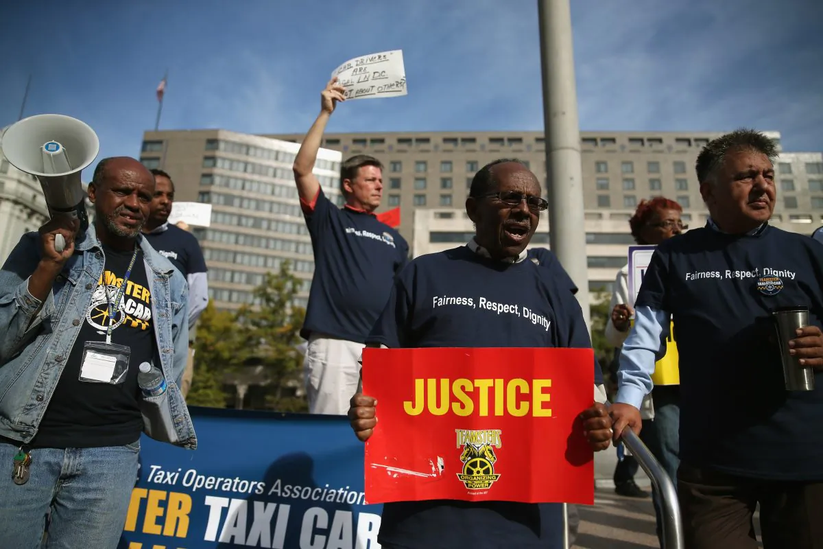Taxi drivers protest on Pennsylvania Ave in front of the D.C. Council's Wilson building, on Oct. 28, 2014 in Washington, DC. Cab drivers are protesting as the D.C. Council is set to give final approval to legislation that will allow app-based car services like Uber and Lyft to continue operating in the District. (Mark Wilson/Getty Images)