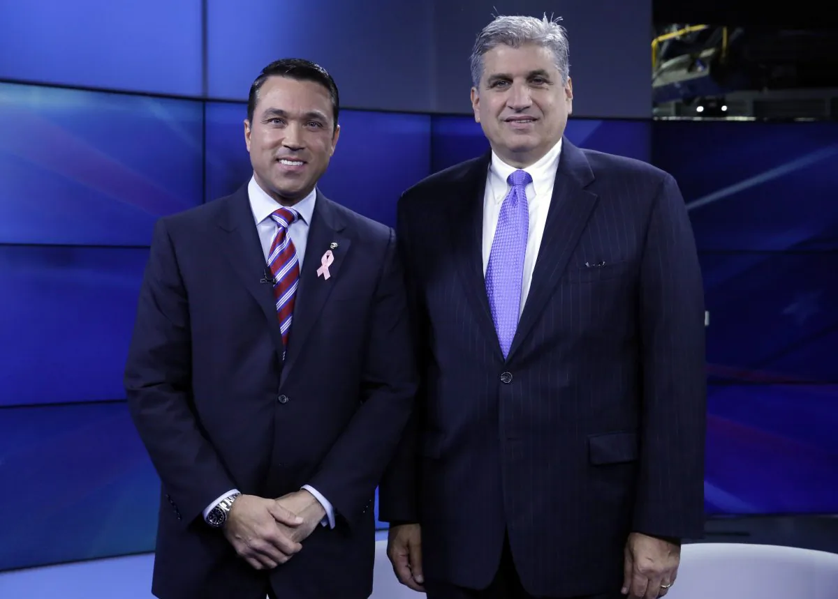 Incumbent Republican Rep. Michael Grimm (L) and Democratic challenger Domenic Recchia, pose for a photo before a recorded, televised debate for the 11th Congressional District race at WABC-TV in New York, Friday, Oct. 17, 2014,. (AP Photo/Richard Drew)