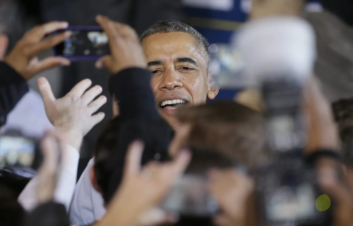 President Barack Obama greets supporters at Wayne State University in Detroit, Saturday, Nov. 1, 2014. Obama's attendance is in support of democrats, gubernatorial candidate Mark Schauer and U.S. Senate candidate Gary Peters. (AP Photo/Carlos Osorio)