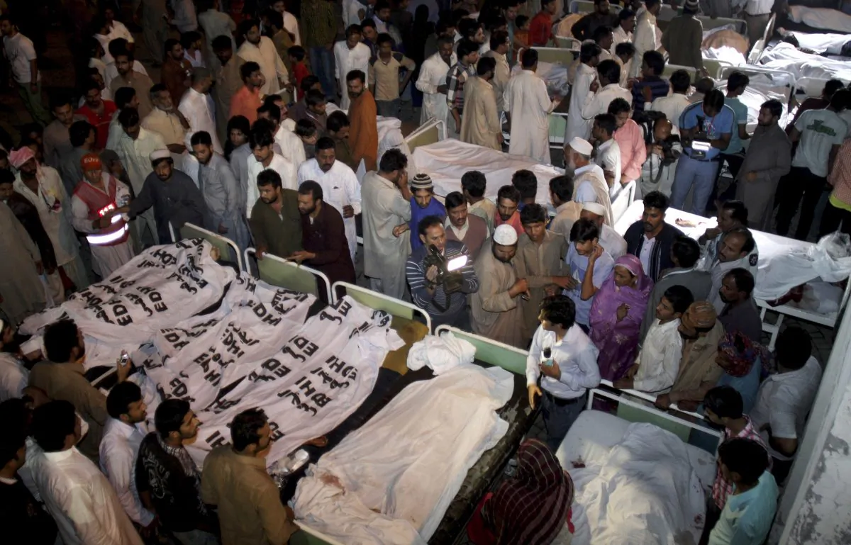 Pakistanis gather to identify bodies of their relatives killed in a bomb blast at a local hospital in Lahore, Pakistan, Nov. 2, 2014. A bomb exploded near a Pakistani paramilitary checkpoint Sunday, killing scores of people near the country's eastern border with India in an attack suspected to be the work of a suicide bomber, police said. (AP Photo/K.M. Chaudary)