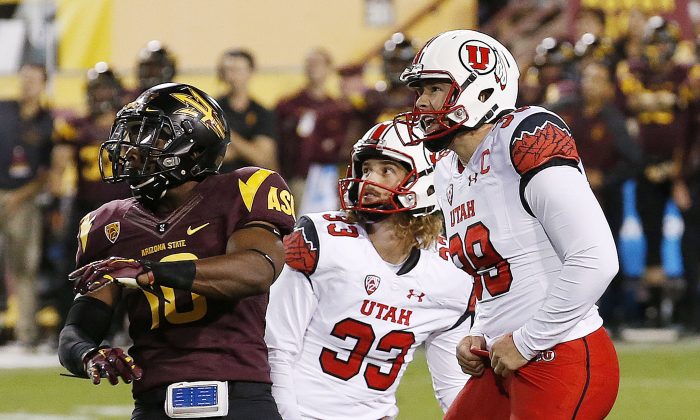 Utah kicker Andy Phillips (39) watches his field goal attempt miss as teammate Tom Hackett (33) looks on and Arizona State's Kweishi Brown, left, waves his arms on the missed attempt in overtime of an NCAA college football game on Saturday, Nov. 1, 2014, in Tempe, Ariz.  Arizona State defeated the Utah 19-16 in overtime. (Photo/Ross D. Franklin)