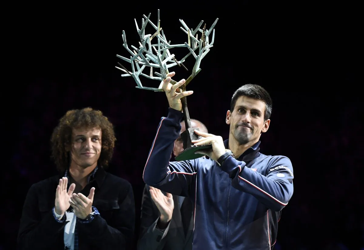 Brazilian football player David Luiz applauds Serbia's Novak Djokovic (R) after winning the final match against Canada's Milos Raonic at the ATP World Tour Masters 1000 indoor tennis tournament on Nov 2, 2014 at the Bercy Palais-Omnisport (POPB) in Paris. (FRANCK FIFE/AFP/Getty Images)