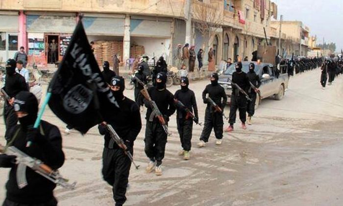 This undated file image posted on a militant website on Jan. 14, 2014, which has been verified and is consistent with other AP reporting, shows fighters from the al-Qaida linked Islamic State of Iraq and the Levant (ISIL) marching in Raqqa, Syria. U.S. Arab allies Egypt, Saudi Arabia, the United Arab Emirates and Kuwait are discussing creation of a military pact to take on Islamic militants, with the possibility of a joint force to intervene around the Middle East, The Associated Press has learned in Nov. 2014. Even if no joint force is agreed on, the alliance would coordinate military action, aiming at quick, pinpoint operations against militants rather than longer missions,  officials said.  (AP Photo/Militant Website, File)
