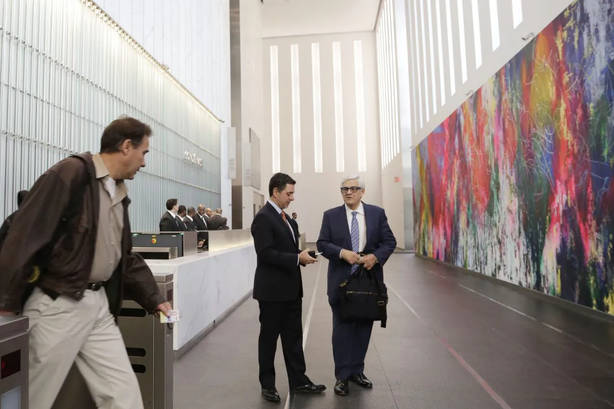 An employee enters the lobby of One World Trade Center in New York on Monday, Nov. 3, 2014. Thirteen years after the 9/11 terrorist attack, the resurrected World Trade Center is again opening for business, marking an emotional milestone for both New Yorkers and the United States as a whole. (AP Photo/Mark Lennihan)