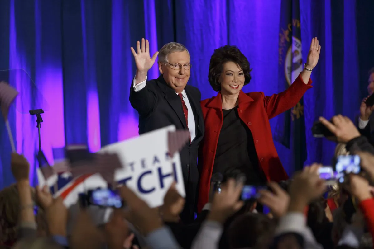Senate Minority Leader Mitch McConnell of Ky.,  joined by his wife, Elaine Chao, celebrates with his supporters at an election night party in Louisville, Ky.,on Nov. 4, 2014.  (AP Photo/Scott Applewhite)