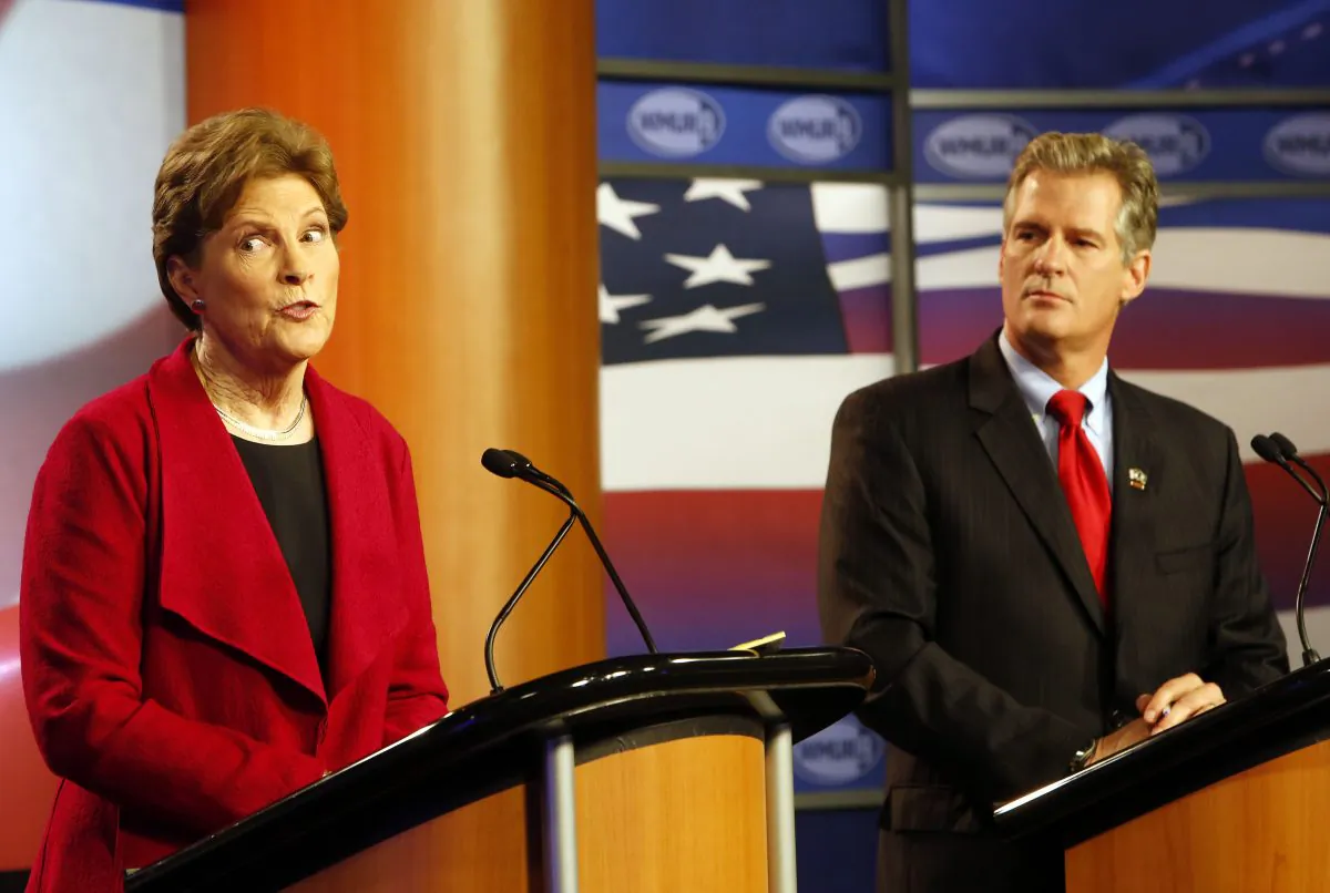 U.S. Sen. Jeanne Shaheen, D-Maine, left, answers a question during a live televised debate with her Republican opponent, former Massachusetts U.S. Sen. Scott Brown, at Saint Anselm College in Manchester, N.H. on Thursday, Oct. 30, 2014. (AP Photo/Jim Cole)