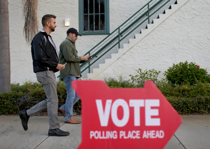 Eric Barenz (L) and David Dean prepare to vote at The Coliseum where a polling station is setup on November 4, 2014 in St Petersburg, United States.