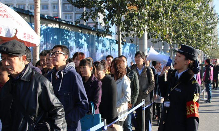 Passengers wait in line to take a subway during the ban on alternate days for odd and even license plates put in place for the APEC Summit, on November 3, 2014 in Beijing, China. Complaints among Beijing residents have grown louder concerning the inconveniences brought on by Beijing, which is seeking to make a good impression on foreign leaders. (ChinaFotoPress/Getty Images)