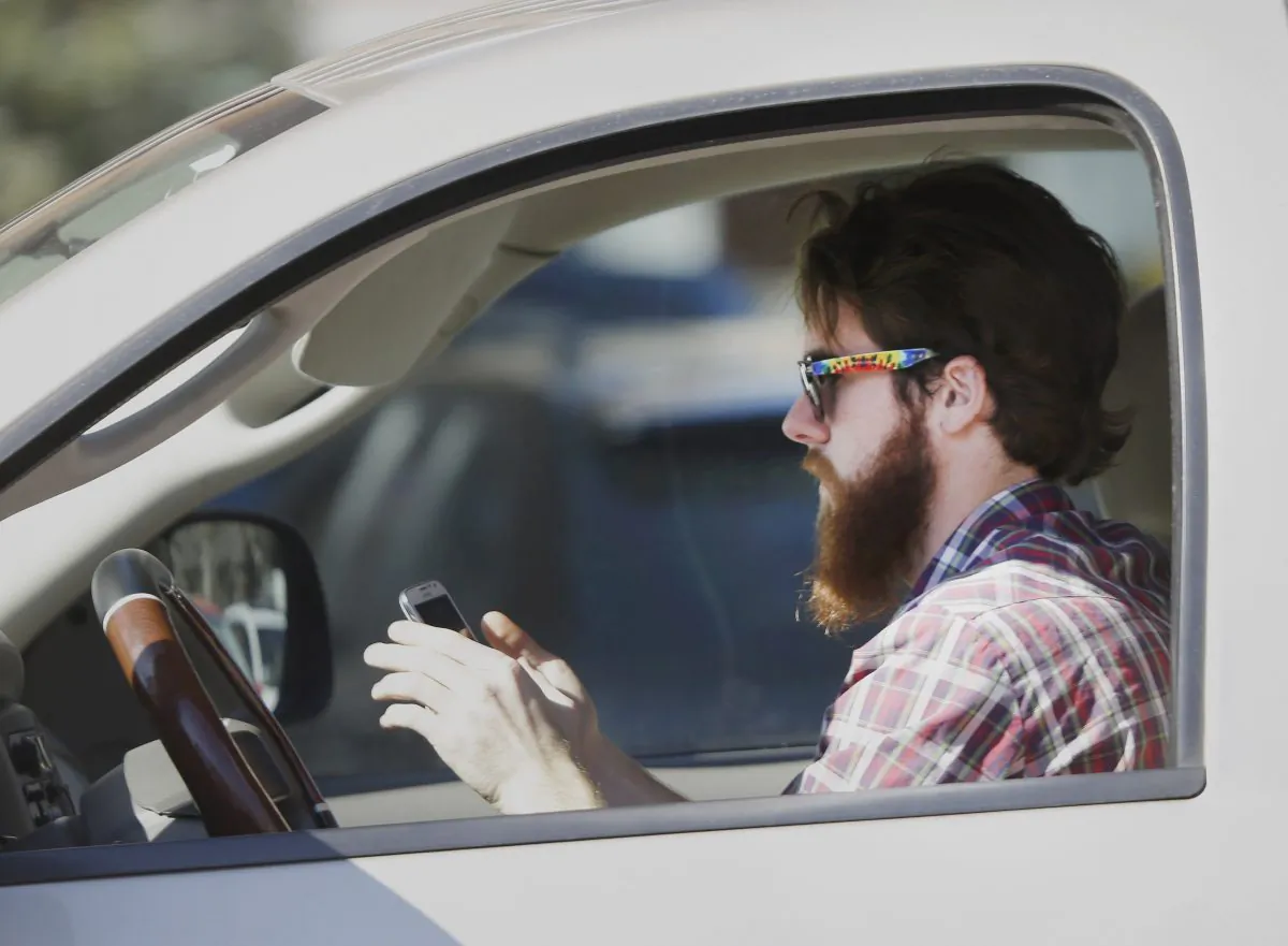 A motorist uses a cellphone. (LM Otero/AP Photo)