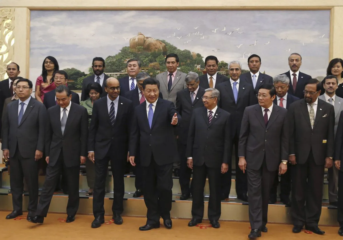 Chinese President Xi Jinping, center, shows the way to guests who attended the signing ceremony of the Asian Infrastructure Investment Bank at the Great Hall of the People in Beijing. China, Oct. 24, 2014.  (AP Photo/Takaki Yajima)
