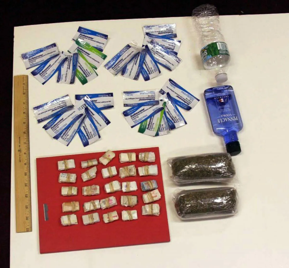 Contraband smuggled by an undercover investigator into Rikers Island jail facilities is shown. During six visits to the New York City jail, the investigator was able to get a plastic bag containing 250 glassine envelopes of heroin; one plastic bag containing 24 packaged strips of suboxone; two plastic bags containing a total weight of one half-pound of marijuana, 16 ounces of vodka in a water bottle, and one razor blade past the personnel at the security entrance. (AP Photo/New York City Department of Investigation)