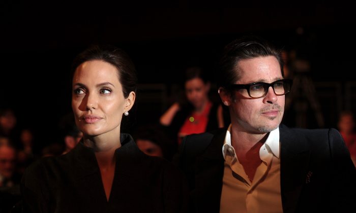 US actress and special UN envoy Angelina Jolie (L) and her husband US actor Brad Pitt attend the fourth day of the Global Summit to End Sexual Violence in Conflict in London on June 13, 2014. (Carl Court/AFP/Getty Images)
