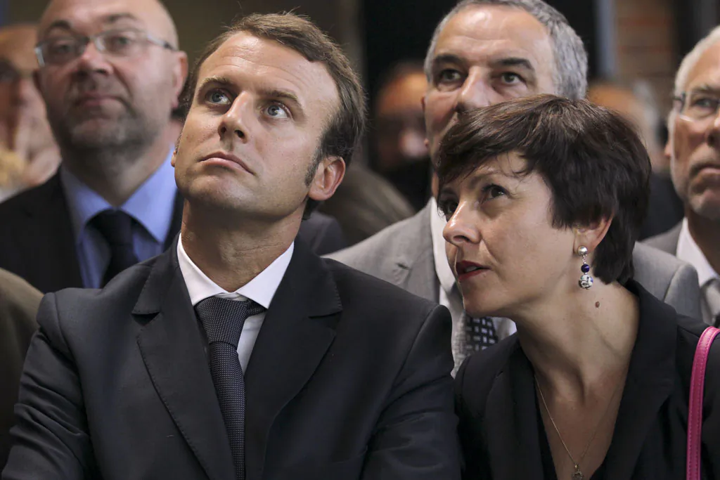 Carole Delga (R), State Secretary in charge of trade, crafts, consumption, and social and solidary economy, is sitting besides Emmanuel Macron (L), Minister of Economy. (Charly Triballeau/AFP/Getty Images)