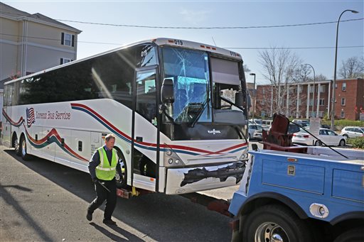 Tom Lynch of Twins Cities Towing and Recovery prepares one of two buses involved in an earlier accident for towing, Sunday, Nov. 2, 2014. Two Washington Redskins team buses collided about 8:15 a.m. Sunday morning on their way to the NFL game vs. the Minnesota Vikings, along eastbound Interstate 94 at the ramp to Huron Ave. Minor injuries were reported, authorities said, but the Redskins said no one on the team was injured. (AP Photo/The Star Tribune, David Denney)