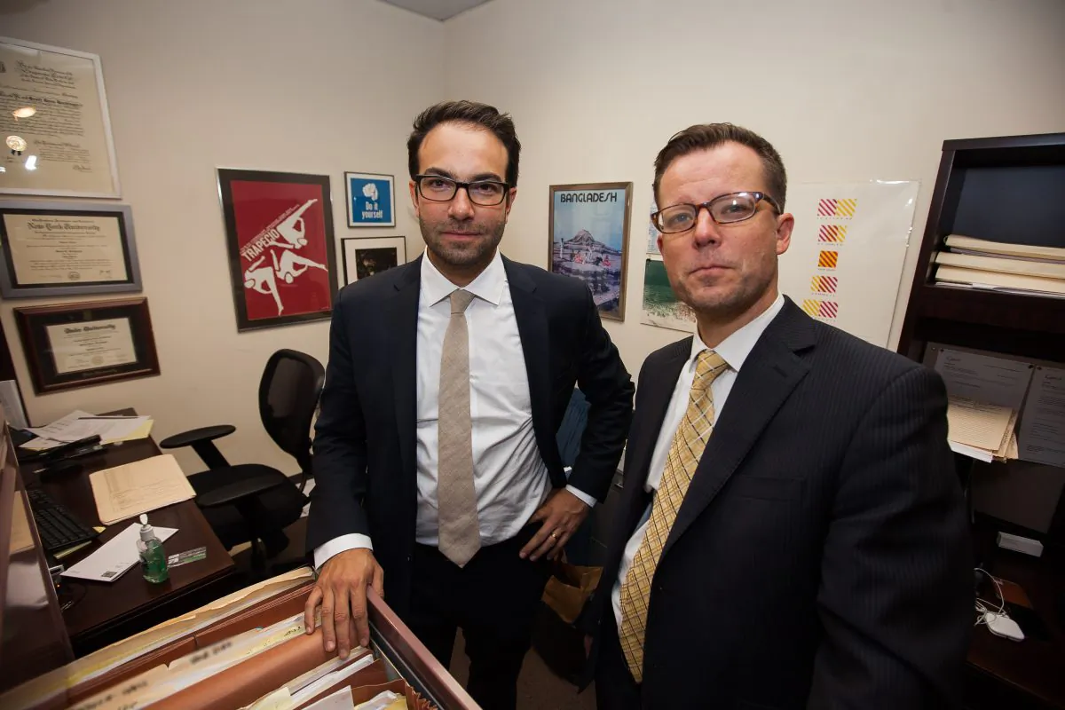Josh Saunders (R) and Scott Hechinger (L), public defenders and co-founders of the Brooklyn Community Bail Fund, in Hechinger‘s office at the Brooklyn Defender Services, Downtown Brooklyn, New York, on Nov. 5, 2014. Brooklyn Defender Services is a public defender office that offers legal and social services to the indigent. (Petr Svab/Epoch Times)