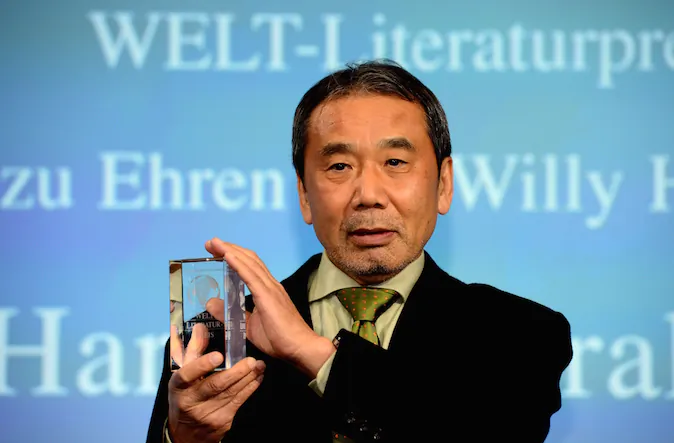 Japanese writer Haruki Murakami poses with his trophy prior to an award ceremony for the Germany's Welt Literature Prize bestowed by the German daily Die Welt, in Berlin on November 7, 2014. (John MacDougall/AFP/Getty Images)