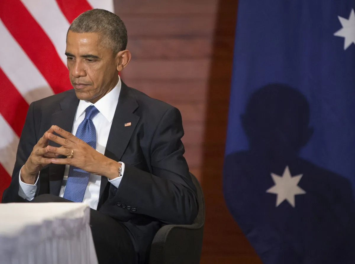 U.S. President Barack Obama listens to Australian Prime Minister Tony Abbott speak during a bilateral meeting in Beijing on Monday. (AP Photo/Pablo Martinez Monsivais)
