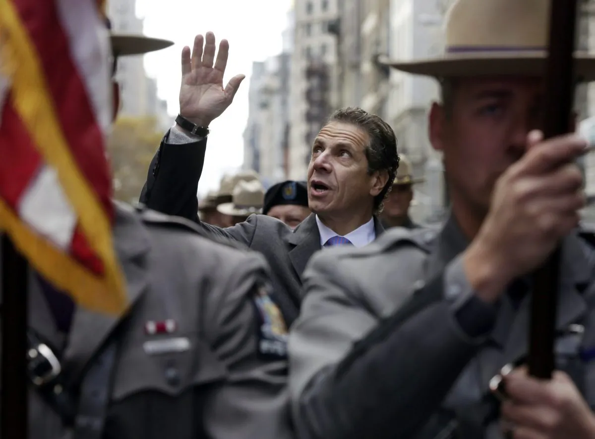 New York Gov. Andrew Cuomo marches in the Veterans Day parade on New York’s Fifth Avenue in Manhattan, N.Y., on Monday, Nov. 11, 2013. Cuomo vetoed legislation that would have authorized state and municipal pension credits for peacetime military service. (AP Photo/Richard Drew)