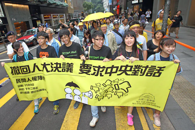 About 1,000 pro-democracy protesters hold a "yellow ribbon" march. Hong Kong Federation of Students leaders seek an audience with Beijing leaders after APEC. (Poon Zai Shu/Epoch Times)