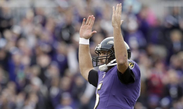 Baltimore Ravens quarterback Joe Flacco reacts to running back Justin Forsett's touchdown during the second half of an NFL football game against the Tennessee Titans in Baltimore, Sunday, Nov. 9, 2014. (AP Photo/Patrick Semansky)