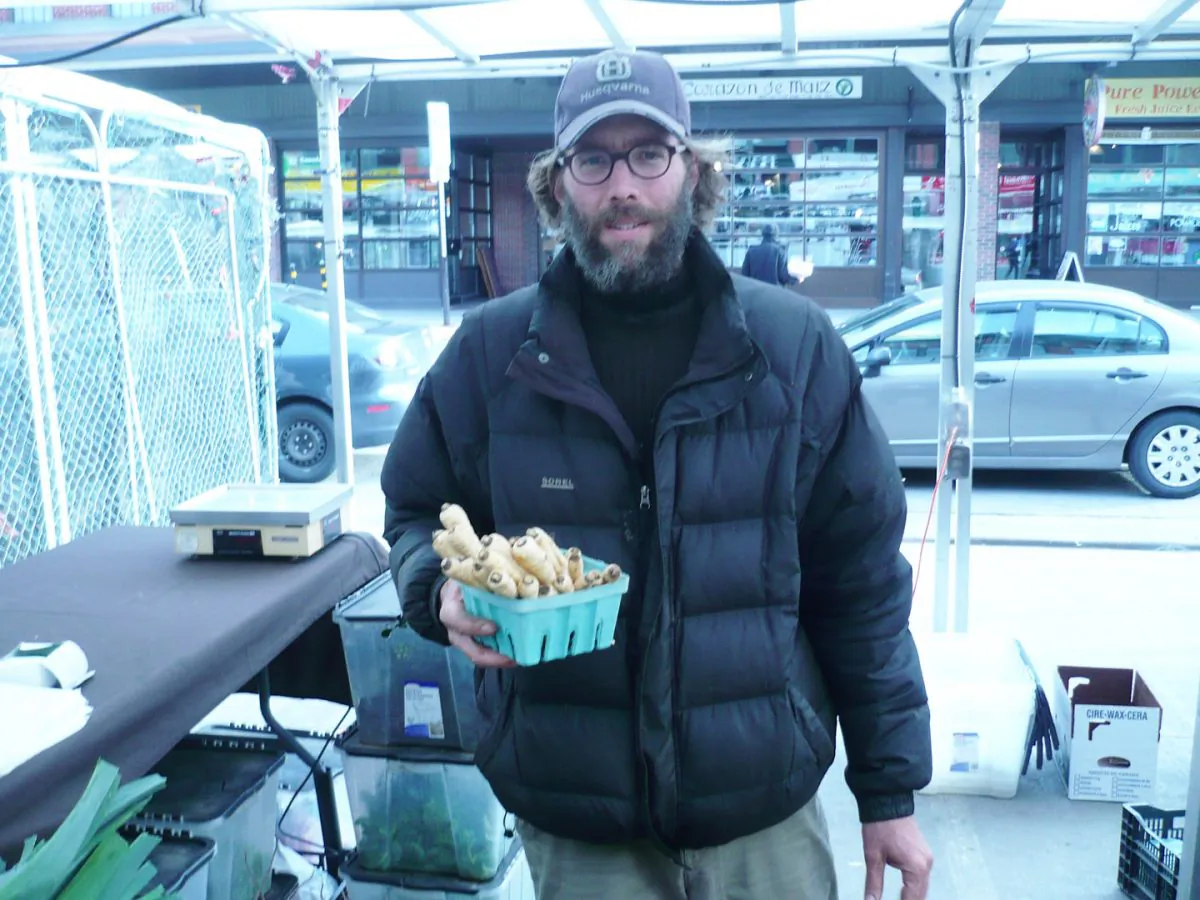 Marc De Repentigny, an organic farmer who studied organic agriculture at Saint-Hippolyte, Quebec, stands in front of his vegetable stall at the ByWard Market in Ottawa. (Susan Hallett)