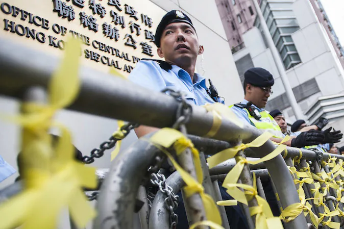 Policemen block the way to the Liaison Government Office in Hong Kong on November 9, 2014. Hundreds of pro-democracy protesters, including leaders of a movement that that has paralysed the streets for weeks, rallied to the city's China office calling for dialogue with Beijing officials. (Xaume Olleros/AFP/Getty Images)
