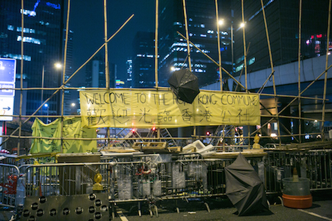 A makeshift barricade made by protesters is on the outskirts of the main protest site in the Central District of Hong Kong on Nov. 11, 2014. Over the past two nights protesters have been adding more and more materials to the barricades making them larger and wider.  (Benjamin Chasteen/Epoch Times)