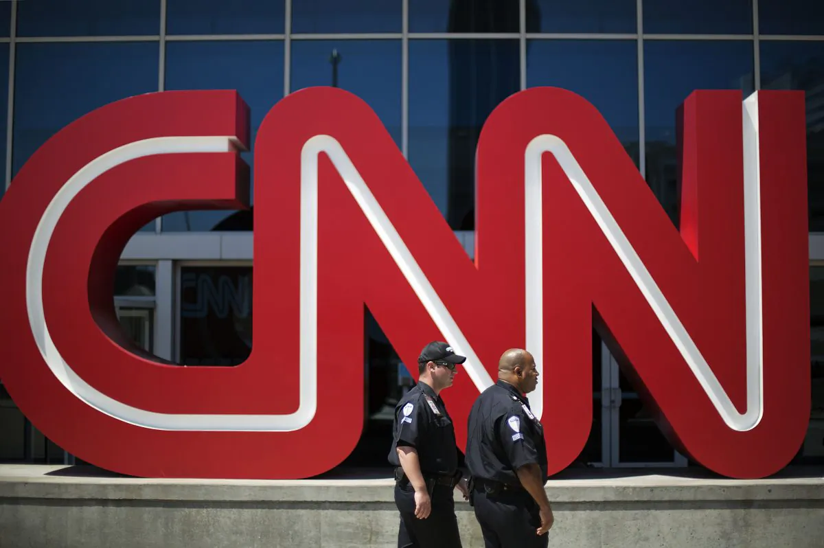 Security guards walk past the entrance to CNN headquarters in Atlanta. (David Goldman/AP Photo)