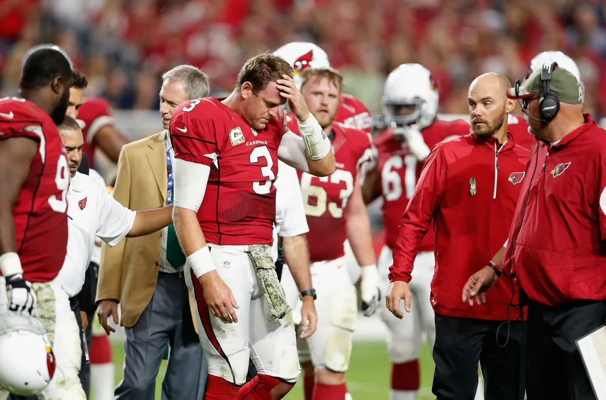  Quarterback Carson Palmer #3 of the Arizona Cardinals is helped off the field after being injured in the fourth quarter of the NFL game against the St. Louis Rams at University of Phoenix Stadium on November 9, 2014 in Glendale, Arizona. The Cardinals defeated the Rams 31-14. (Photo by Christian Petersen/Getty Images)