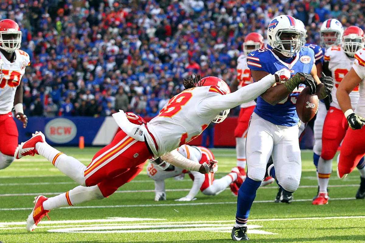 Kansas City Chiefs strong safety Ron Parker, left, forces a fumble off Buffalo Bills running back Bryce Brown during the second half of an NFL football game, Sunday, Nov. 9, 2014, in Orchard Park, N.Y. (AP Photo/Bill Wippert)