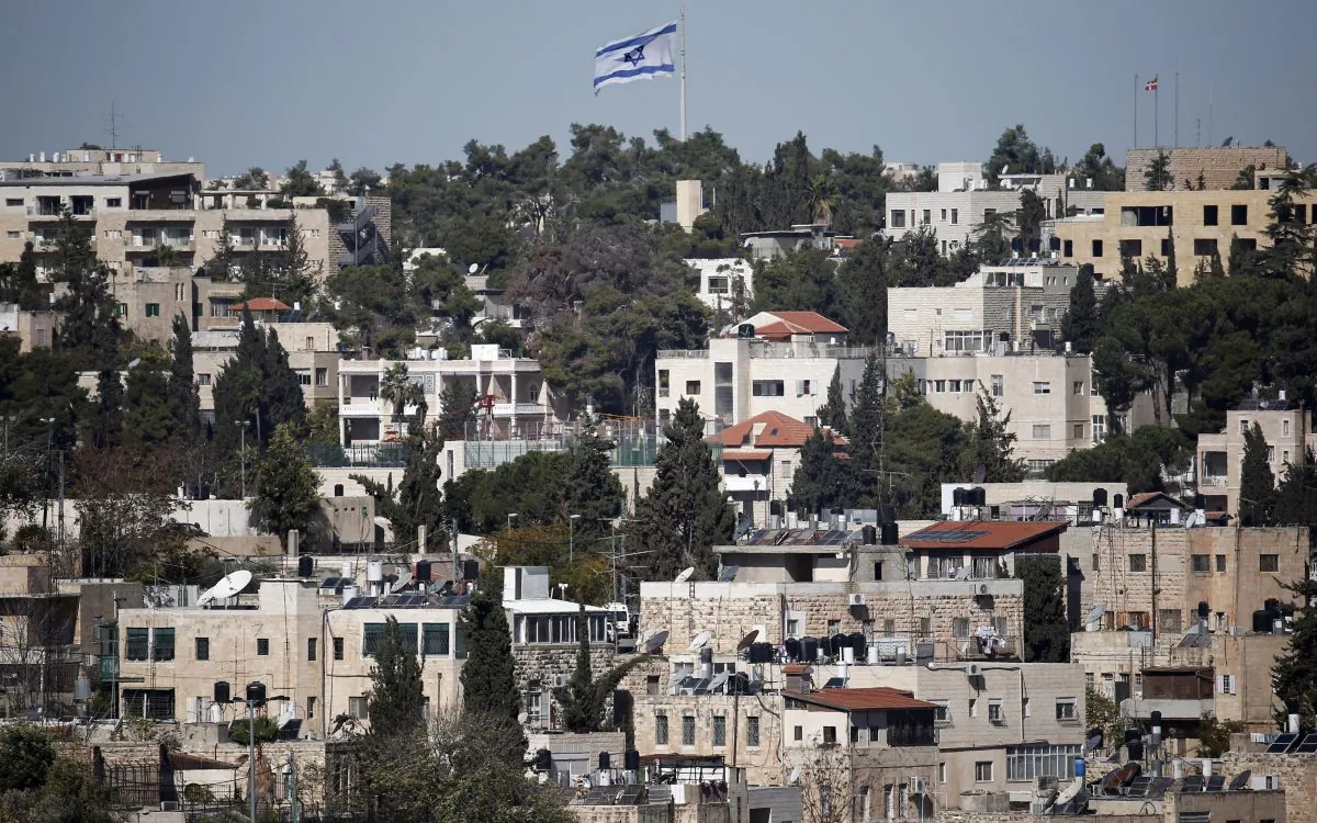 A giant Israeli flag flies over the Palestinian neighbourhood of Wadi Joz in East Jerusalem on Nov. 11, 2014. (Thomas Coex/AFP/Getty Images)