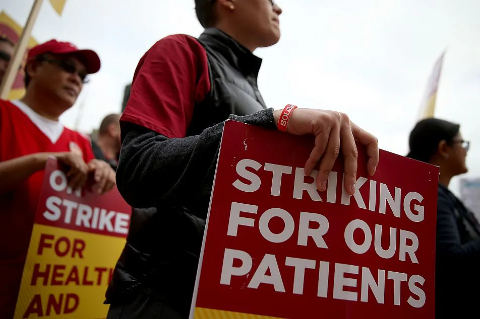 Nurses carry signs as they strike outside of Kaiser Permanente hospital on November 11, 2014 in San Francisco, Calif. Registered nurses (RN) have decided to go on strike in fourteen U.S. states for being on the frontlines of caring for potential Ebola patients while their demands for greater safety are not met. (Justin Sullivan/Getty Images)