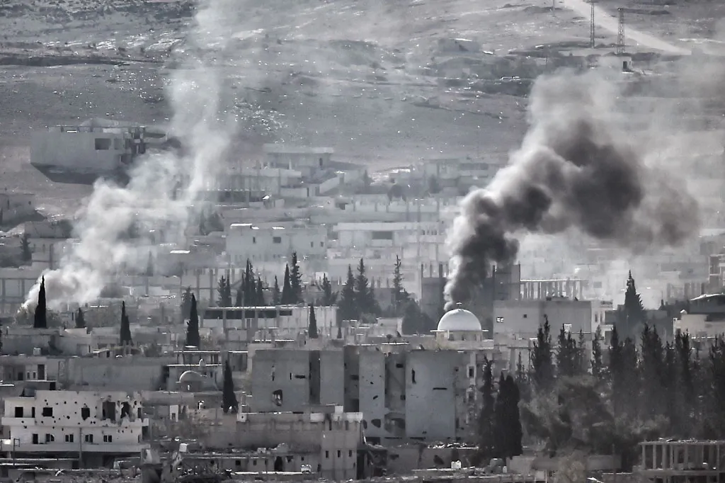 Smoke rises after the shelling of the city of Kobani, also known as Ain al-Arab, as it seen from the Turkish border village of Mursitpinar, Sanliurfa province, on Nov. 12, 2014. (Aris Messinis/AFP/Getty Images)