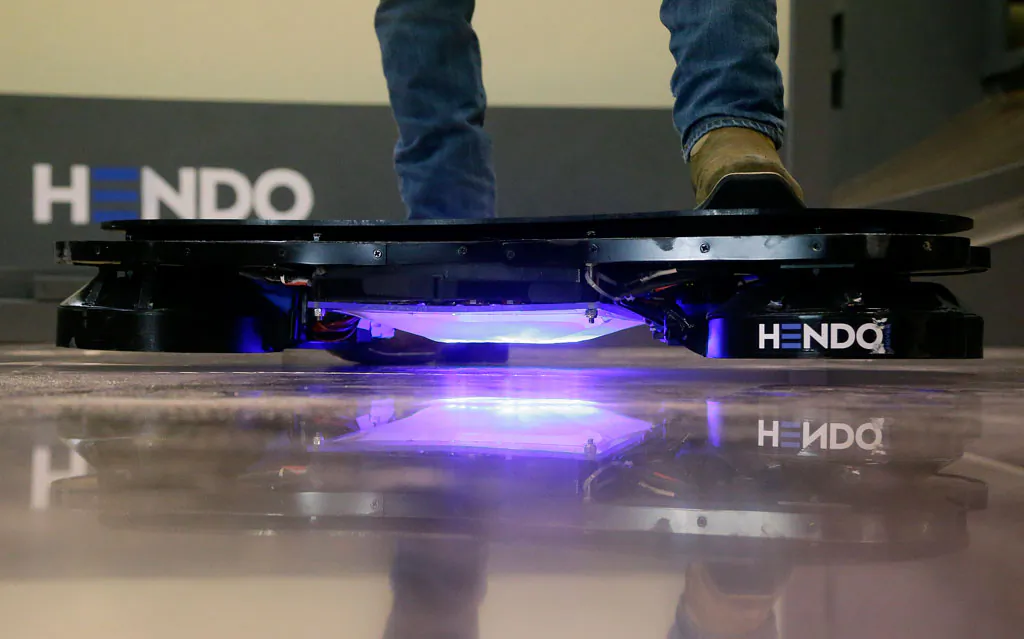 Arx Pax engineer Garrett Foshay stands over a Hendo Hoverboard in Los Gatos, Calif., on Oct. 30, 2014. Skateboarding is going airborne this fall with the launch of the first real commercially marketed hoverboard which uses magnetics to float about an inch off the ground. (AP Photo/Jeff Chiu)