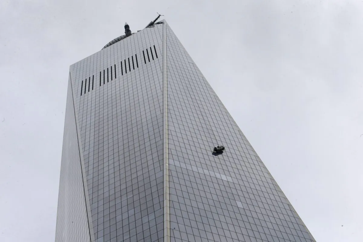 A partially collapsed scaffolding hangs from the 1  World Trade Center in New York, Wednesday, Nov. 12, 2014. New York City firefighters have been called to the nation's tallest skyscraper, where two workers are stuck on scaffolding 69 stories above street level. (AP Photo/Kathy Willens)