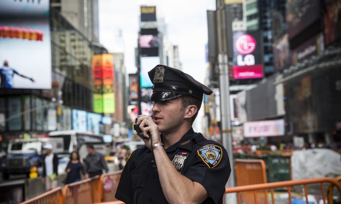 A New York Police Department (NYPD) officer speaks on his radio in Times Square on September 22, 2013 in New York City. (Andrew Burton/Getty Images)
