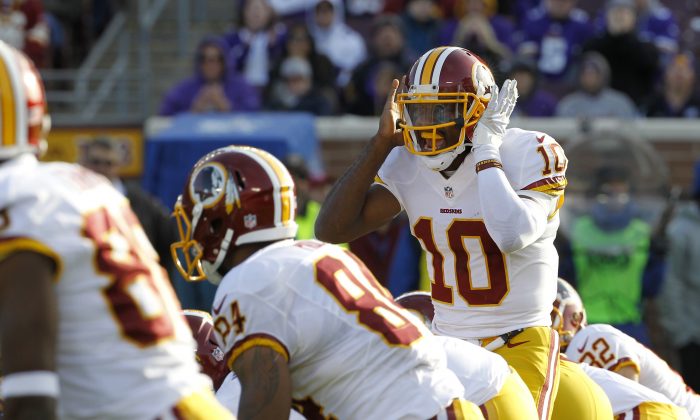 Washington Redskins quarterback Robert Griffin III (10) calls out a play during the second half of an NFL football game against the Minnesota Vikings, Sunday, Nov. 2, 2014, in Minneapolis. (AP Photo/Ann Heisenfelt)