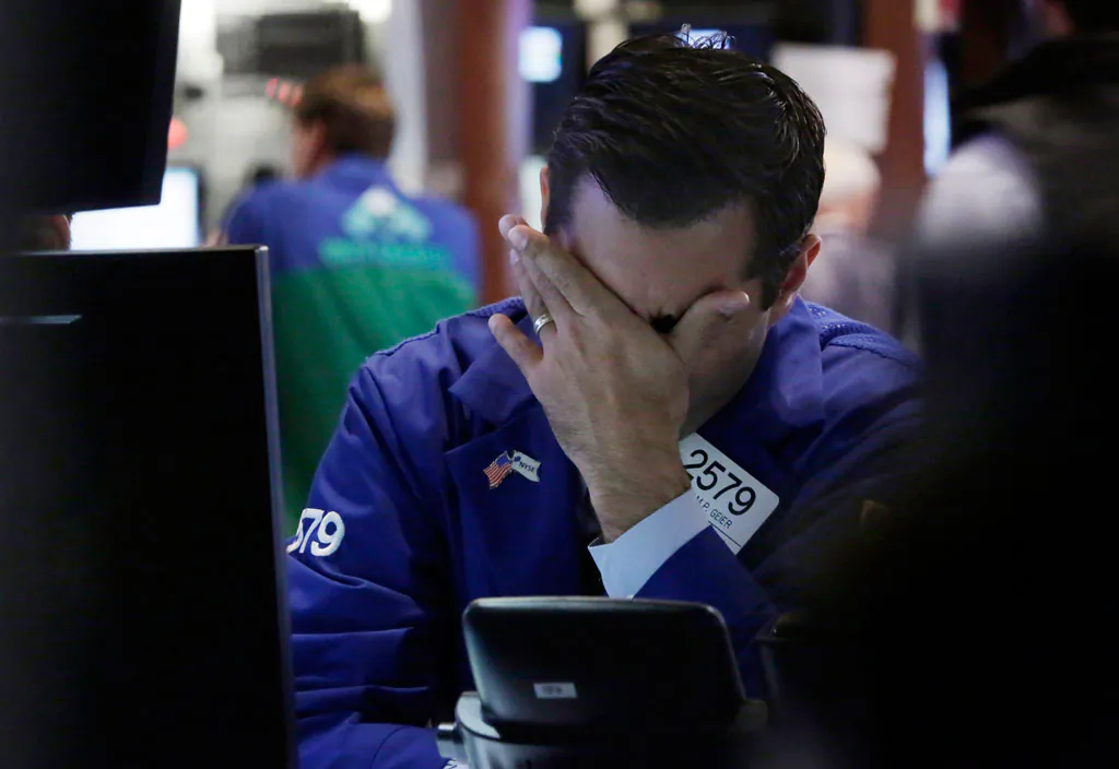Specialist William Geer works at a post on the floor of the New York Stock Exchange on Oct. 16, 2014. (AP Photo/Richard Drew)