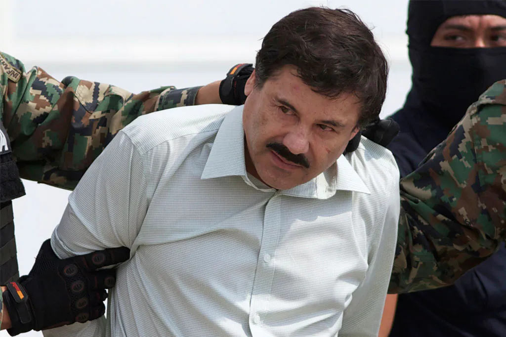 Joaquin "El Chapo" Guzman, the head of Mexico’s Sinaloa Cartel, being escorted to a helicopter in Mexico City following his capture overnight in the beach resort town of Mazatlan, on Feb. 22, 2014. (AP Photo/Eduardo Verdugo)