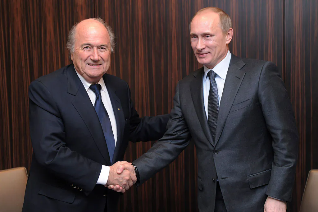 Russian Prime Minister Vladimir Putin (R) shakes hands with FIFA President Joseph Blatter after Russia was announced as the host for the 2018 soccer World Cup in Zurich, Switzerland. (AP Photo/Kurt Schorrer)