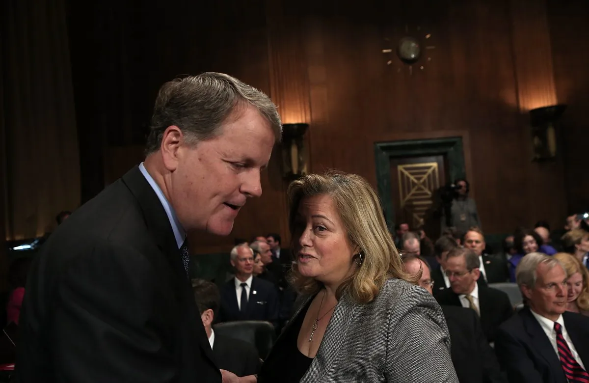 Douglas Parker (L), chairman and CEO of the US Airways Group, speaks with lobbyist Hillary Rosen before a hearing of the Senate Judiciary Committee in Washington, D.C., on March 19, 2013. Parker and Horton testified before the committee on the topic of The American Airlines/US Airways Merger: Consolidation, Competition, and Consumers. (Win McNamee/Getty Images)