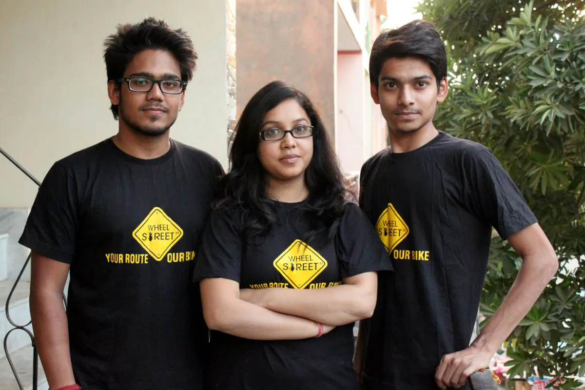 Mritunjaya Kumar (L), Moksha Shrivastav (C), and Pranay Shrivastav (R) the core team of Wheelstreet.in, India's first bike rental portal,
outside their office in Noida City on Nov. 2, 2014. (Venus Upadhayaya/Epoch Times)