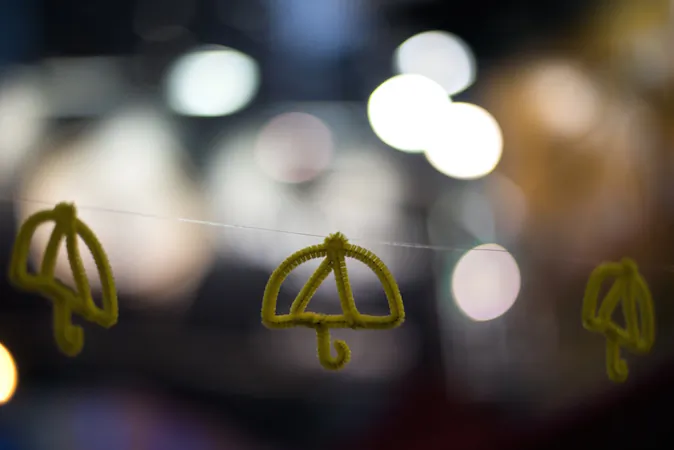 An installation of paper umbrellas -- symbols of the pro-democracy protests in Hong Kong -- hangs across a blockaded road in the Causeway Bay district of Hong Kong on December 14, 2014. (Alex Ogle/AFP/Getty Images)