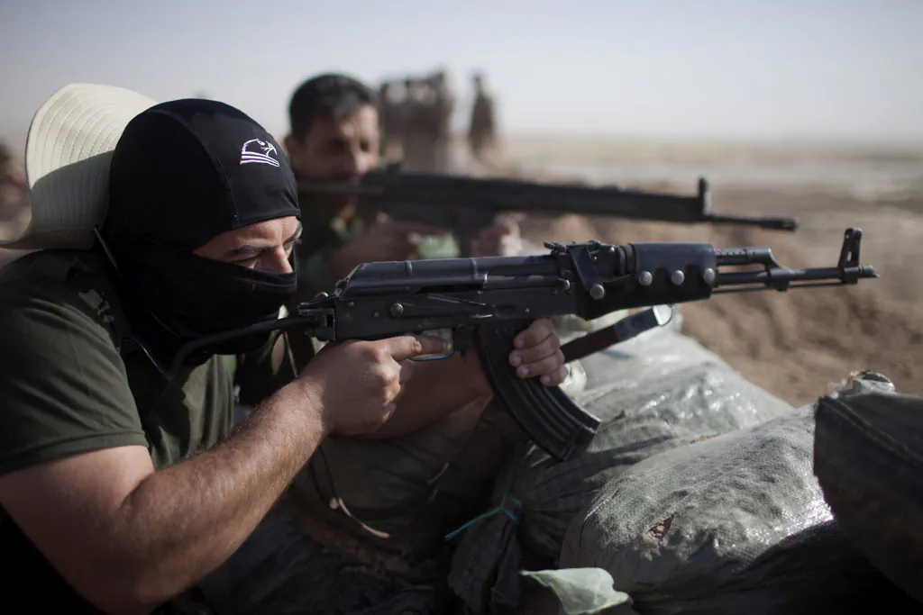 Kurdish Peshmerga fighters hold a position at a frontline in Yangije, where heavy clashes against Islamic States (IS) fighters took place the previous night, 50 kms east of Tikrit, on Sept. 11, 2014. (J.M. Lopez/AFP/Getty Images)