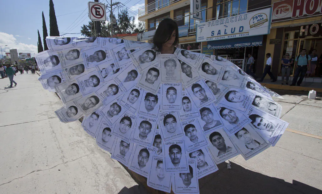 People take part in a protest in Chilpancingo, Guerrero State, Mexico, on Nov. 14, 2014, to demand the safe return of 43 students who went missing in southern Mexico after an attack by gang-linked police last Sept. 26. Rocked by the massacre of 43 students who disappeared in late Sept., Mexico has appointed a new head of human rights to the lead the violence-plagued country's abuse-investigating body. (Hector Guerrero/AFP/Getty Images)