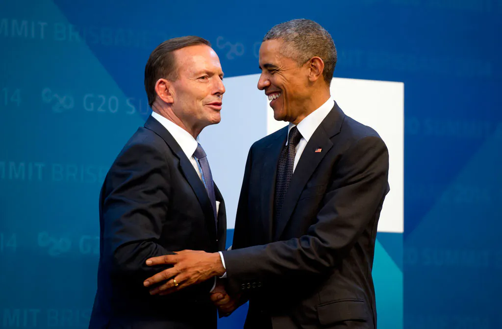 US President Barack Obama (R) is welcomed by Australia's Prime Minister Tony Abbott upon arrival for the G20 Summit in Brisbane, Australia, Saturday, Nov. 15, 2014. (AP Photo/Alain Jocard)