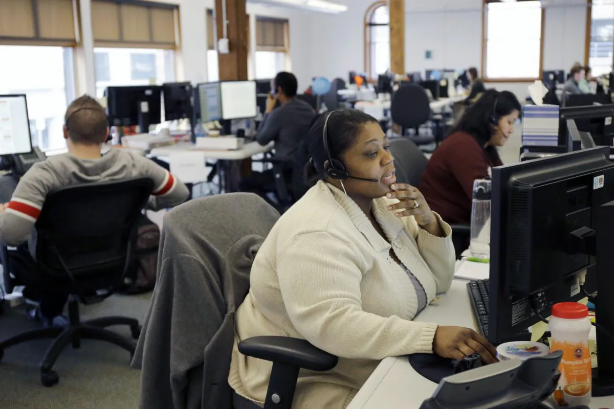Loretha Cager talks with an applicant at MNSure's call center in St. Paul, Minn., March 31, 2014. When MNsure launched Oct. 1, 2013, the help line had only 22 staffers, who were quickly overwhelmed by frustrated shoppers. More than 300 call center workers will be standing by this year, and more than 1,000 trained "assisters" will be available statewide to provide free in-person help to anyo